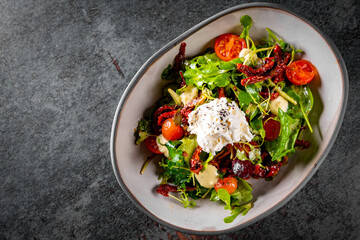 Sun dried tomatoes Salad with fresh vegetables mix and cheese on plate