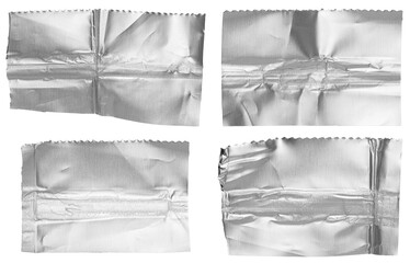 Set of cut out torn crumpled strips of bright shiny metallic aluminium foil, isolated on white or...