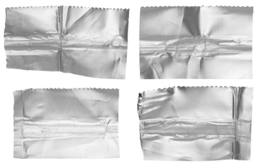 Set of cut out torn crumpled strips of bright shiny metallic aluminium foil, isolated on white or transparent background