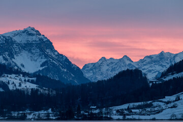 Pink sunset sky Alps Switzerland