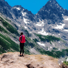 A Hiking girls with backpack in the mountains 