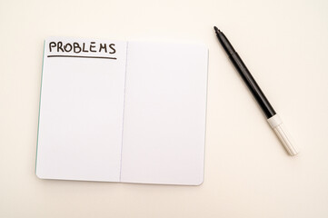 Blank notebook page, with the writing Problems, and marker next to it. Problems, solutions and answers.