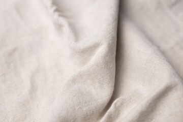 Fototapeta premium Natural linen fabric texture. Rough crumpled burlap background. Selective focus