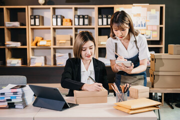 Young Asian man and woman at office of their business online shopping.In home office