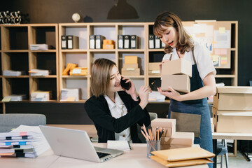 Young Asian man and woman at office of their business online shopping.In home office