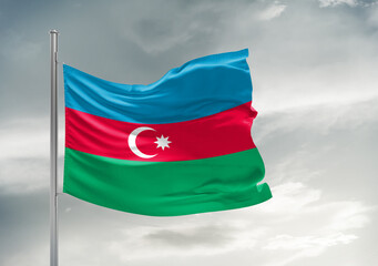 Azerbaijan national flag cloth fabric waving on beautiful sky Background.