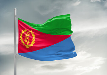 Eritrea national flag cloth fabric waving on beautiful sky Background.