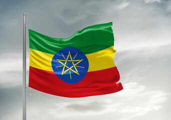 Ethiopia national flag cloth fabric waving on beautiful sky Background.