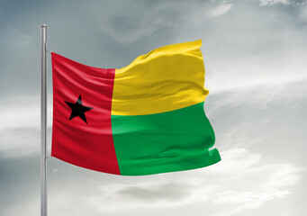 Guinea-Bissau national flag cloth fabric waving on beautiful sky Background.