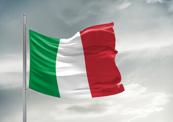 Italy national flag cloth fabric waving on beautiful sky Background.