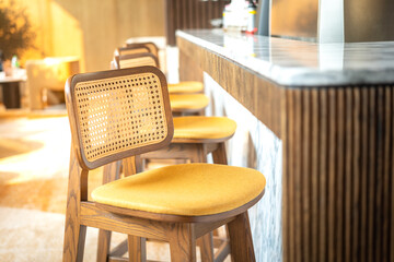 A cozy designed of tall chair in a row at counter beverage bar of the hotel lobby. Interior...