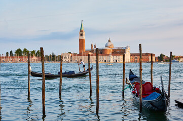 Scenic view of building across the water in Venice from a harbor with gondolas