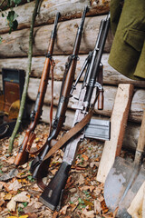 Closeup of guns leaning on a wooden house in a garden