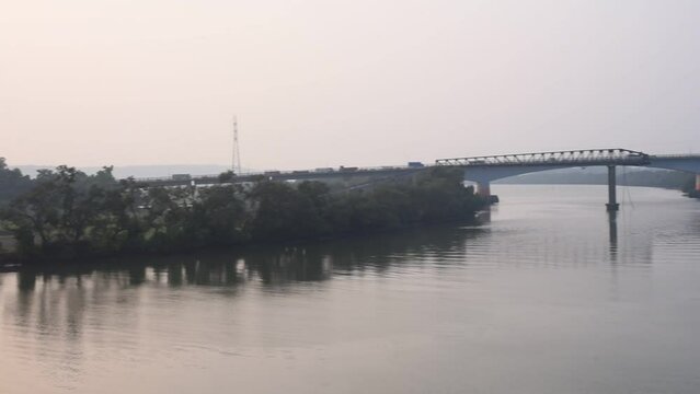 Beautiful view of a bridge and a lake with a boat on a cloudy day