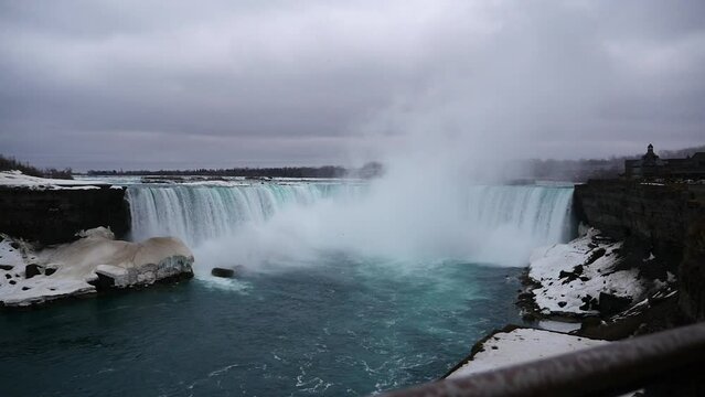 Beautiful view of the Niagara Falls in Ontario, Canada with steam rising towards the dark cloudy sky