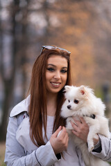Portrait of a young adult woman with a dog