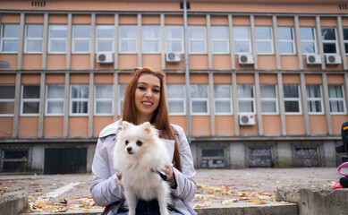 Portrait of a young adult woman with a dog