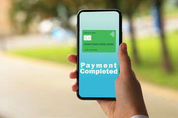 Woman successfully made payment using online banking application on smartphone outdoors, closeup