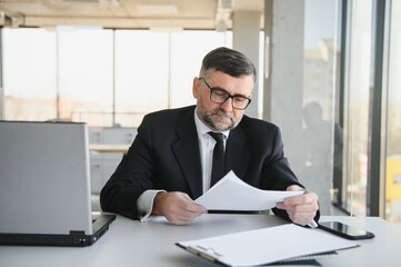 Angry businessman with document shouting at somebody