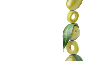 Cut and whole green olives with leaves on white background