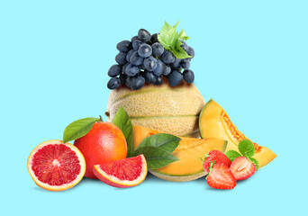 Many different fresh fruits on light blue background