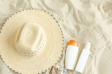 Summer travel beach flat lay composition, copy space. Straw hat, sunglasses, sunscreen lotion,...