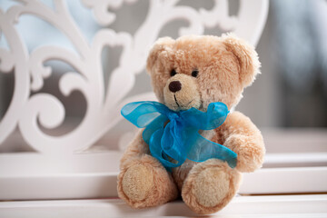Teddy bear with a blue bow.
