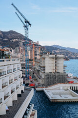 Monaco, Monaco - 28.12.2021 : Construction of new quarters in Monaco with the help of a superstructure on the sea