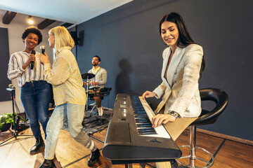 Business people making team training exercise during team building seminar singing karaoke.