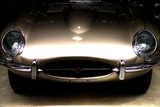 Closeup of the front of a Jaguar E-Type Convertible HDR Black in a garage