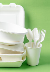 The Eco friendly biodegradable paper disposable for packaging food and paper glass on green...