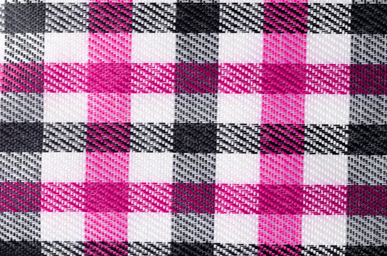 The Pink and Black color Gingham pattern fabric texture as background.