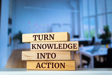 Wooden blocks with words 'TURN KNOWLEDGE INTO ACTION'.