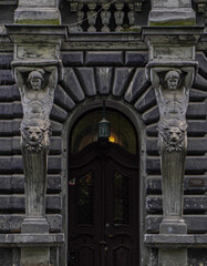 Fototapeta na wymiar Old facade with atlas statues 
