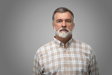 Portrait of happy casual mature man smiling, senior age man with gray hair, Isolated on gray...