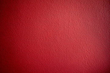 Red grainy background texture of a wall