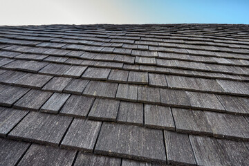 Low angle closeup shot of the roof of a house on a farm against the blue sky