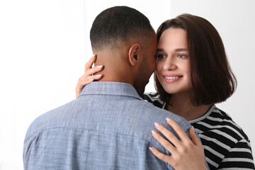 Dating agency. Woman hugging her boyfriend on white background
