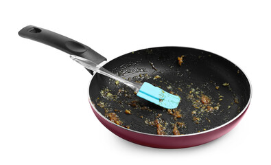 Dirty frying pan and spatula on white background