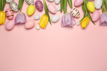 Flat lay composition with festively decorated Easter eggs and beautiful tulips on pink background. Space for text
