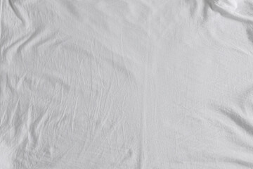 Naklejka premium Crumpled white fabric as background, top view