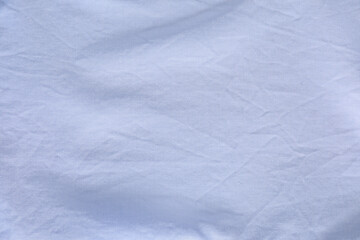 Crumpled light blue fabric as background, top view