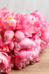 Beautiful pink peonies on wooden table, closeup