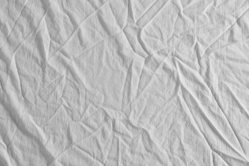Fototapeta na wymiar Crumpled white fabric as background, top view