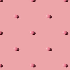 Pink pills on a pink  background. Seamless pattern for the background. Medical pharmacy flat lay design for presentation packaging, website, flyer, cover business cards.