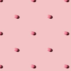 White pills on a pink  background. Seamless pattern for the background. Medical pharmacy flat lay design for presentation packaging, website, flyer, cover business cards.