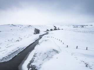 Une petite rivière sur le plateau de l'aubrac en plein hiver sous la neige