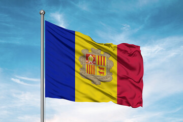 Andorra national flag cloth fabric waving on beautiful sky Background.