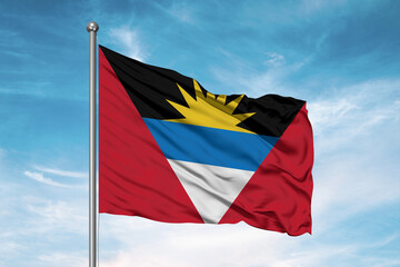 Antigua and Barbuda national flag cloth fabric waving on beautiful sky Background.