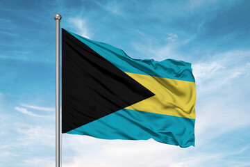 The Bahamas national flag cloth fabric waving on beautiful sky Background.